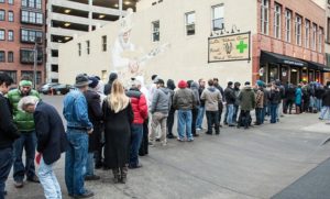 Denver, United States. 1st January 2014 -- The line started in pre-dawn and grew far down the street before the Lodo Wellness Center, a pot dispensary in Denver Colorado, opened their doors. 