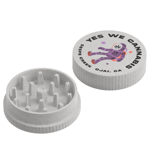 A two-piece speckled gray hemp plastic herb grinder showing the inside teeth base and the top lid printed with a purple astronaut and the text "YES WE CANNABIS," "SESPE CREEK," and "OJAI, CA."